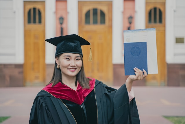 bachelor holding diploma