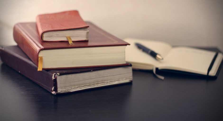 pen notebook and books on the table